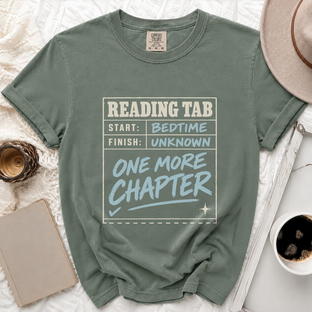 Green t-shirt with "Reading Tab: Start Bedtime, Finish Unknown, One More Chapter" graphic.