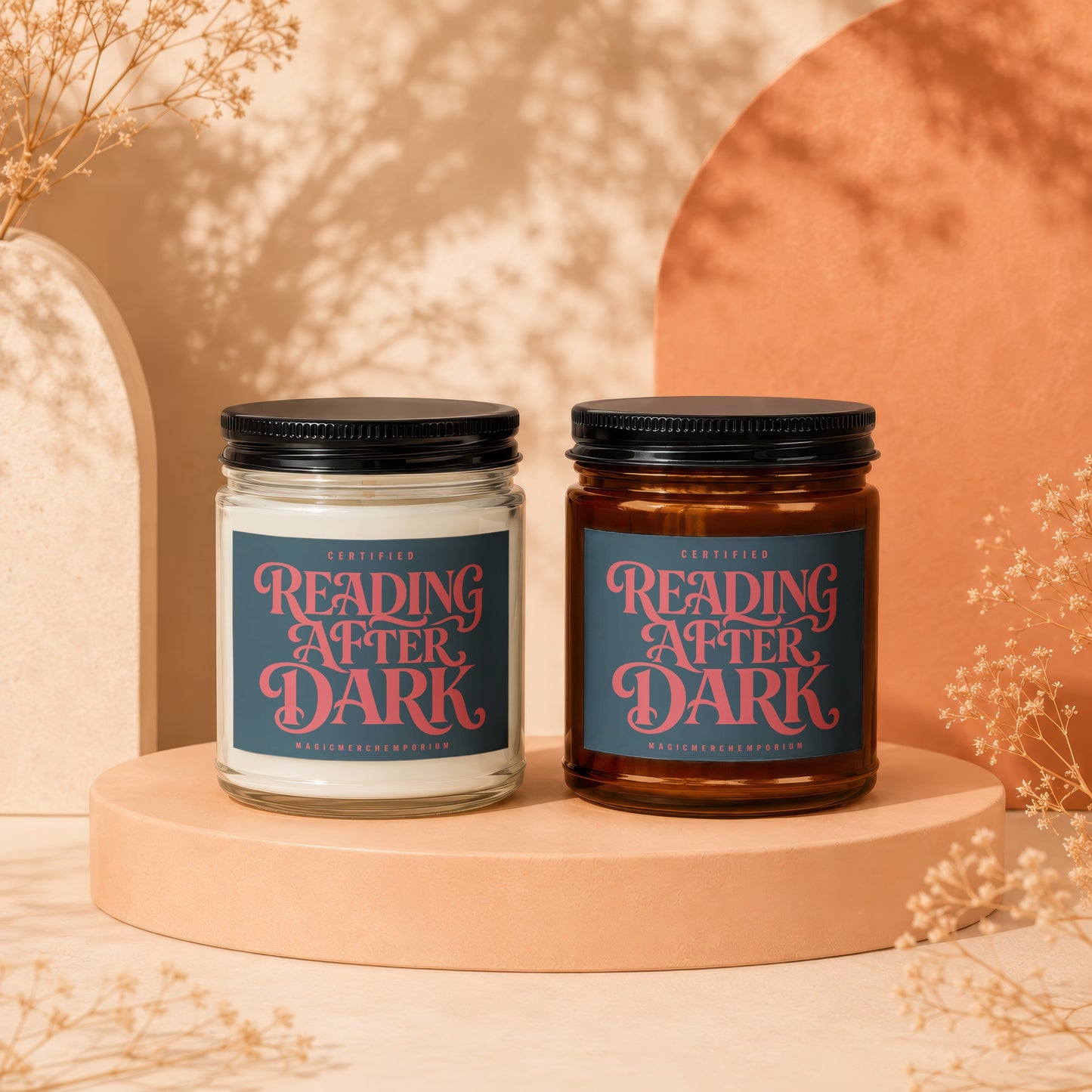 Two "Reading After Dark" candles on pedestals with decorative branches and shadows.