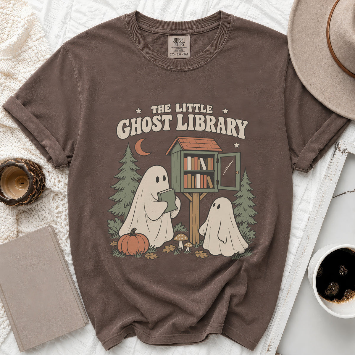 Brown t-shirt with "The Little Ghost Library" graphic featuring ghosts and a book stand.