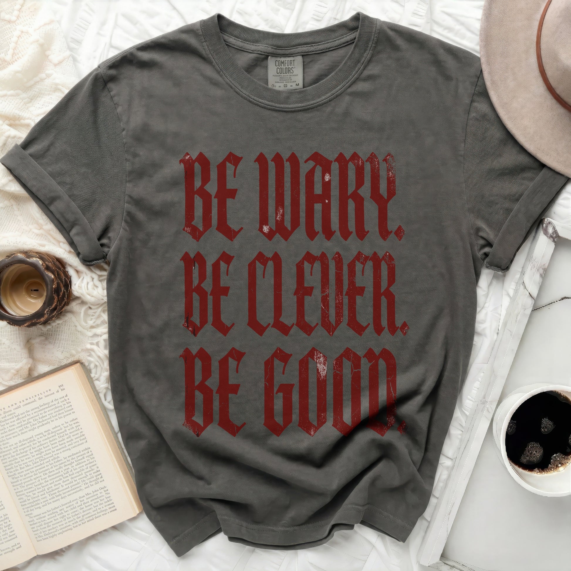 Gray t-shirt with red gothic text: BE WARY. BE CLEVER. BE GOOD.
