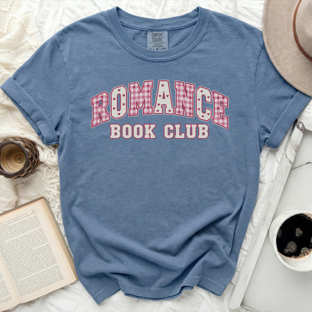 Blue t-shirt with "ROMANCE BOOK CLUB" text in pink and white plaid.