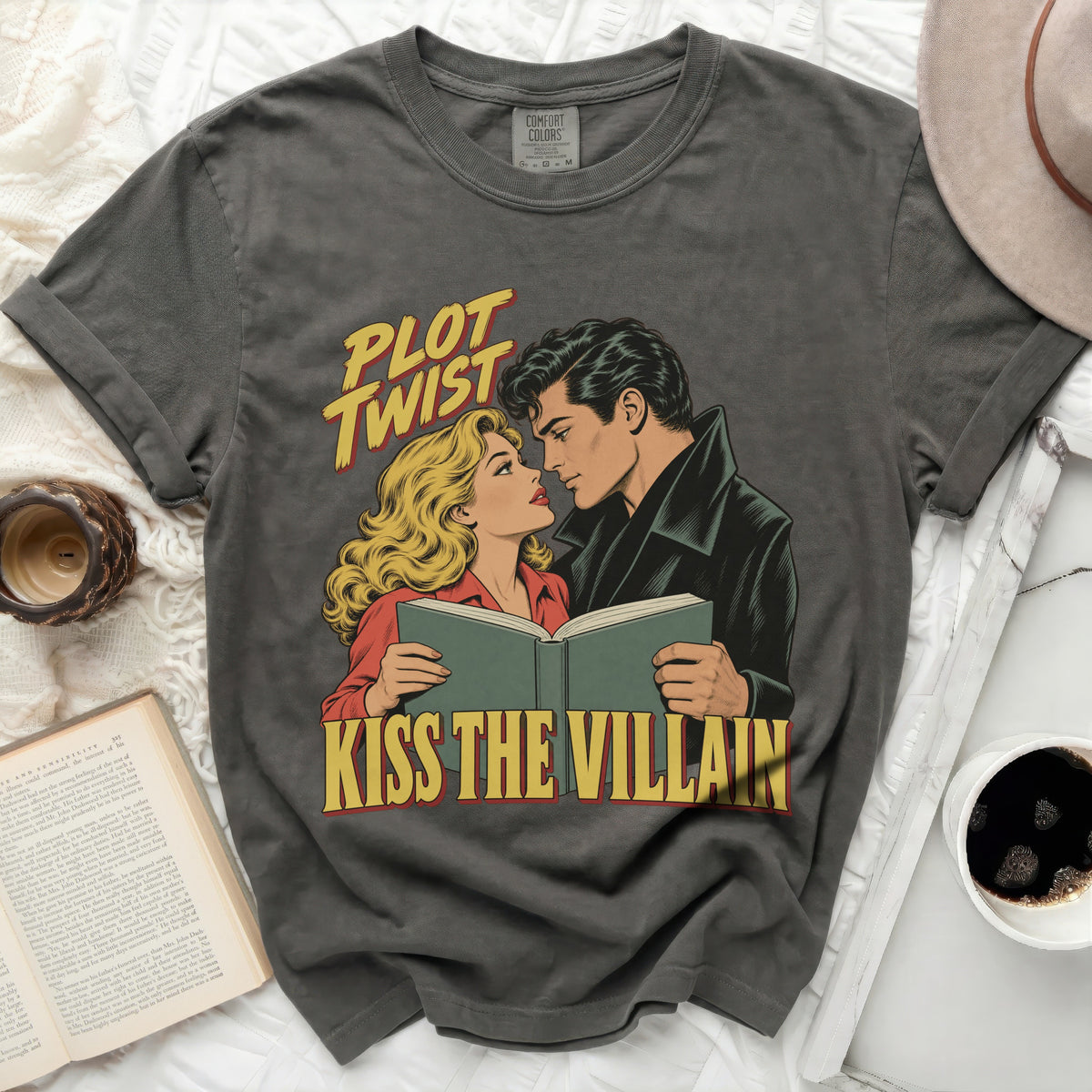 Dark grey t-shirt with "Plot Twist" and "Kiss the Villain" comic art.