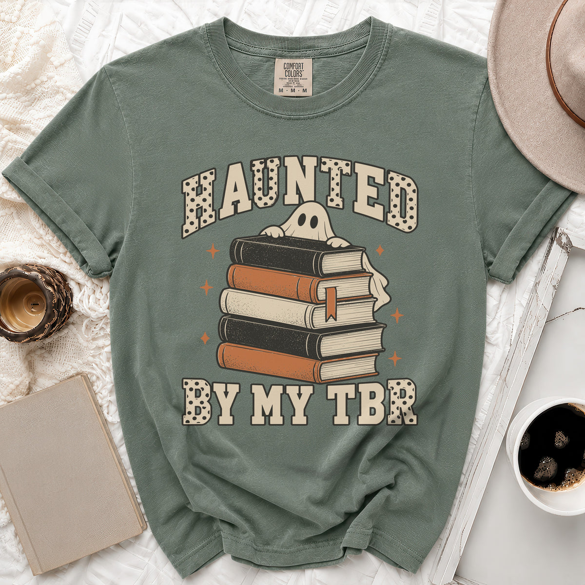 Green t-shirt with "Haunted By My TBR" text and a ghost over books.