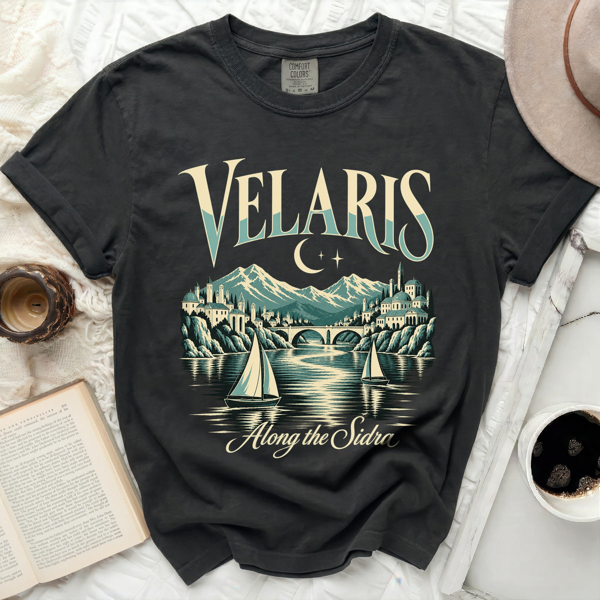 Dark t-shirt with "Velaris Along the Sidro" graphic featuring a cityscape and sailboats.
