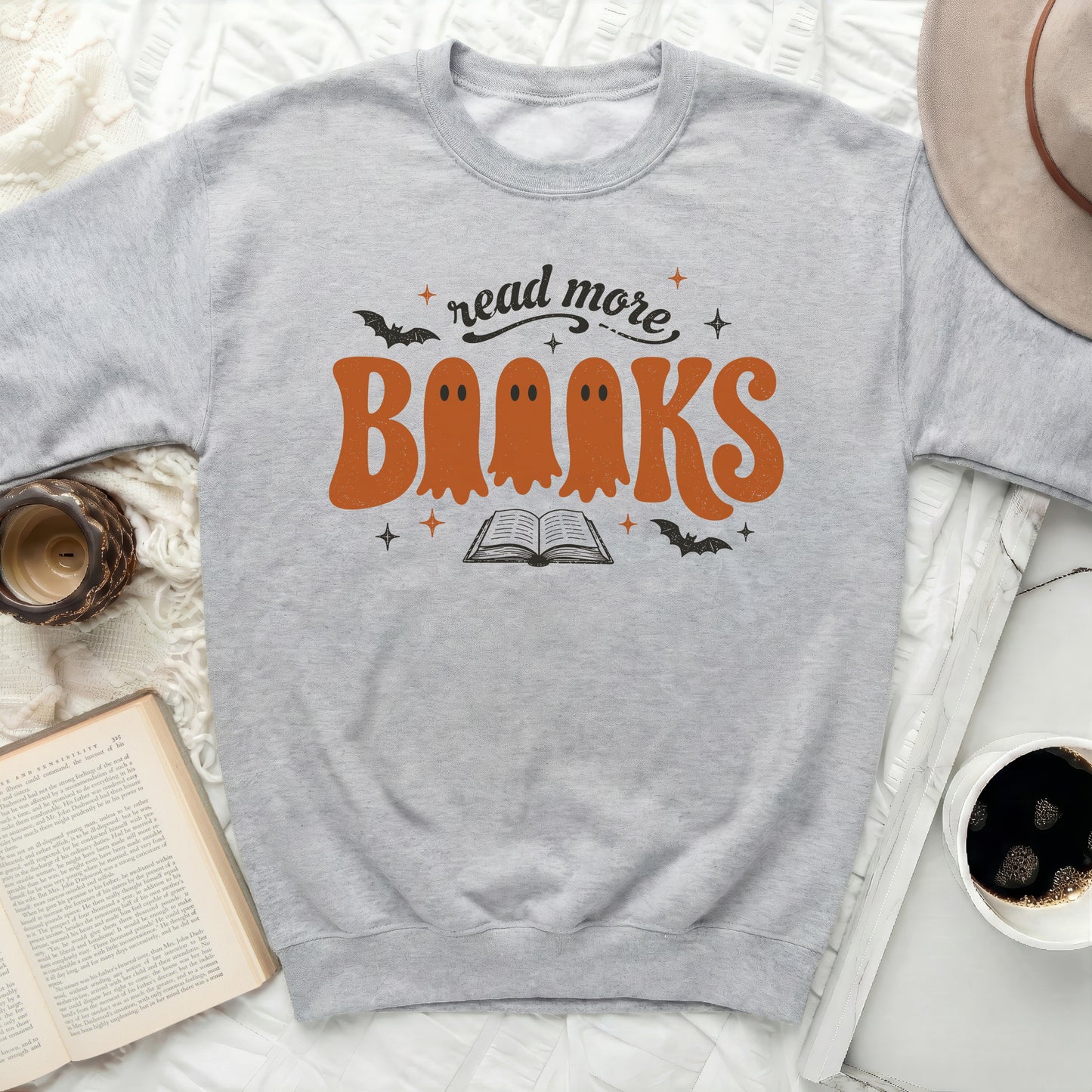 Grey sweatshirt with orange ghost "Books" text and "read more" above.