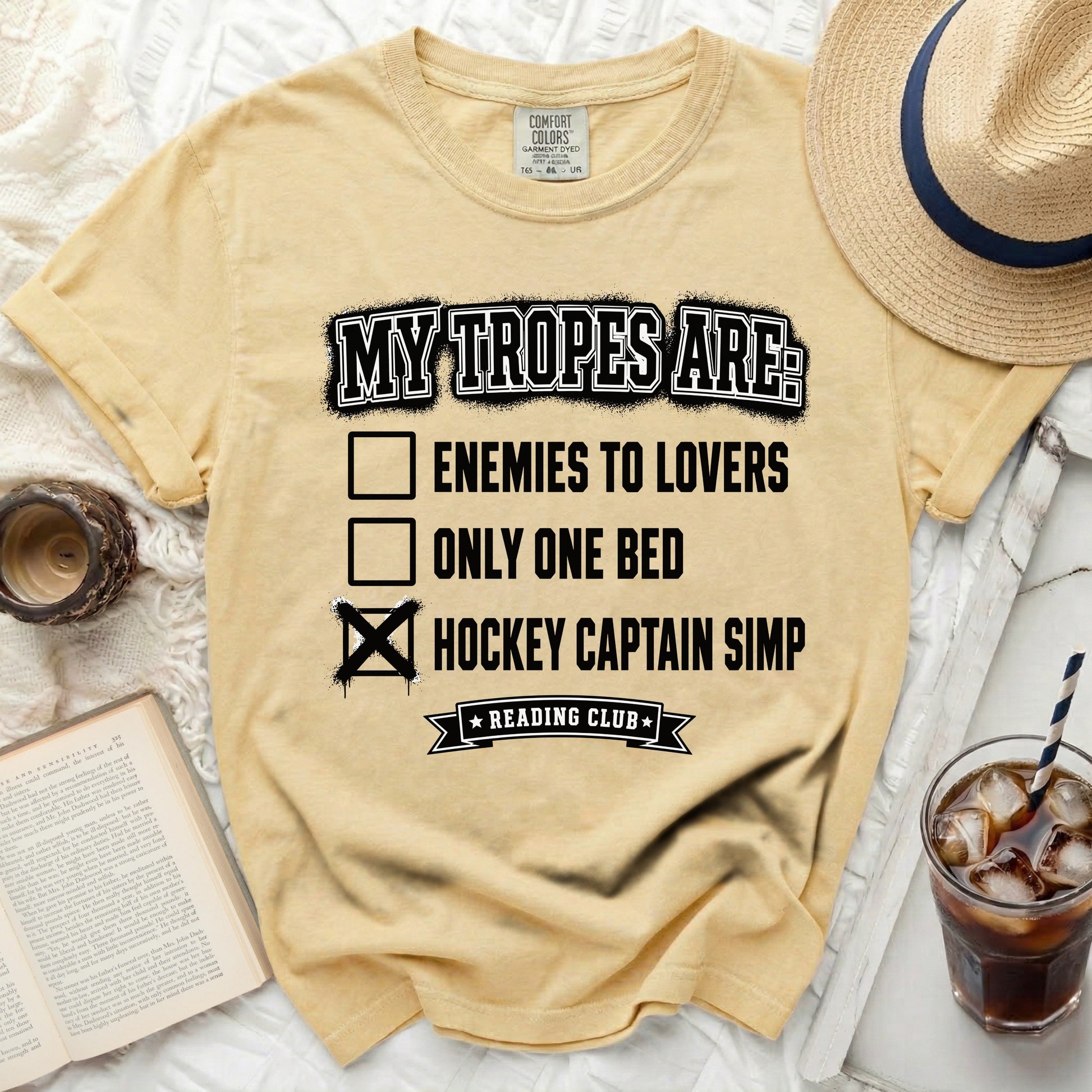 Yellow t-shirt with "My Tropes Are" checklist featuring "Hockey Captain Simp."