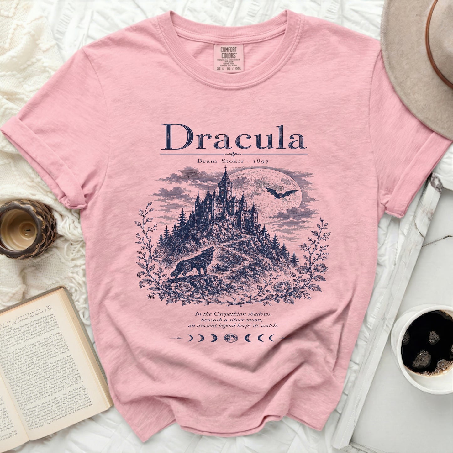 Pink t-shirt with "Dracula" art featuring a castle, wolf, and moon.