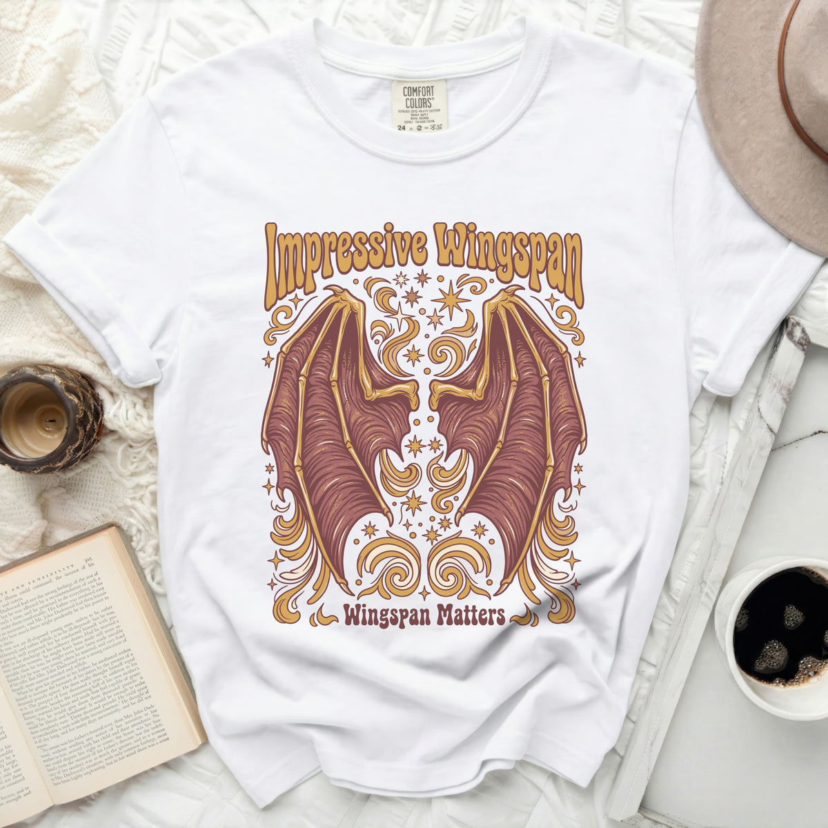 White t-shirt with "Impressive Wingspan" and bat wings graphic.