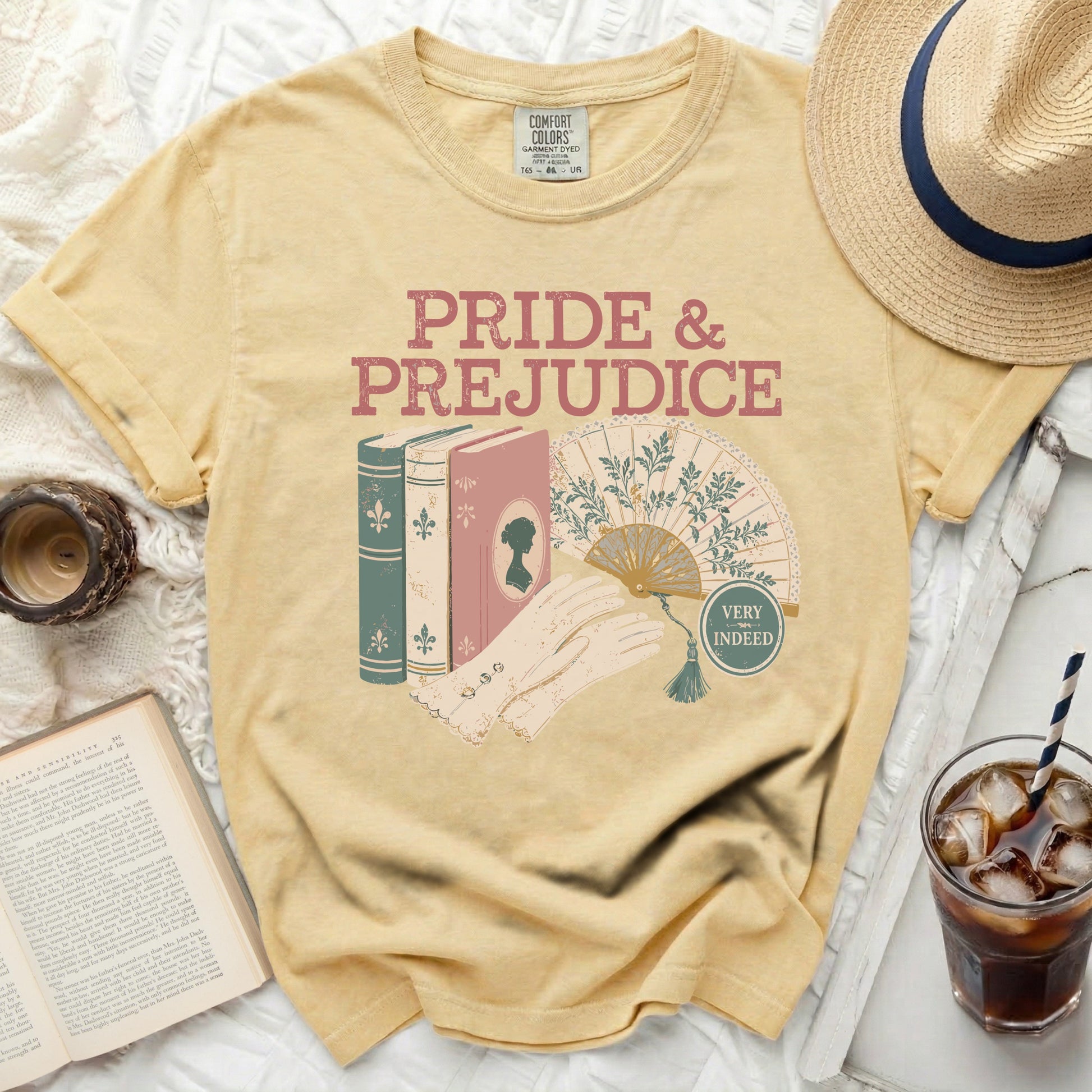 Yellow t-shirt with "Pride & Prejudice" graphic, books, fan, and gloves.