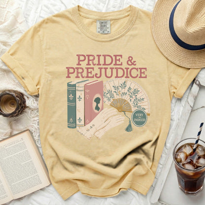 Yellow t-shirt with "Pride & Prejudice" graphic, books, fan, and gloves.