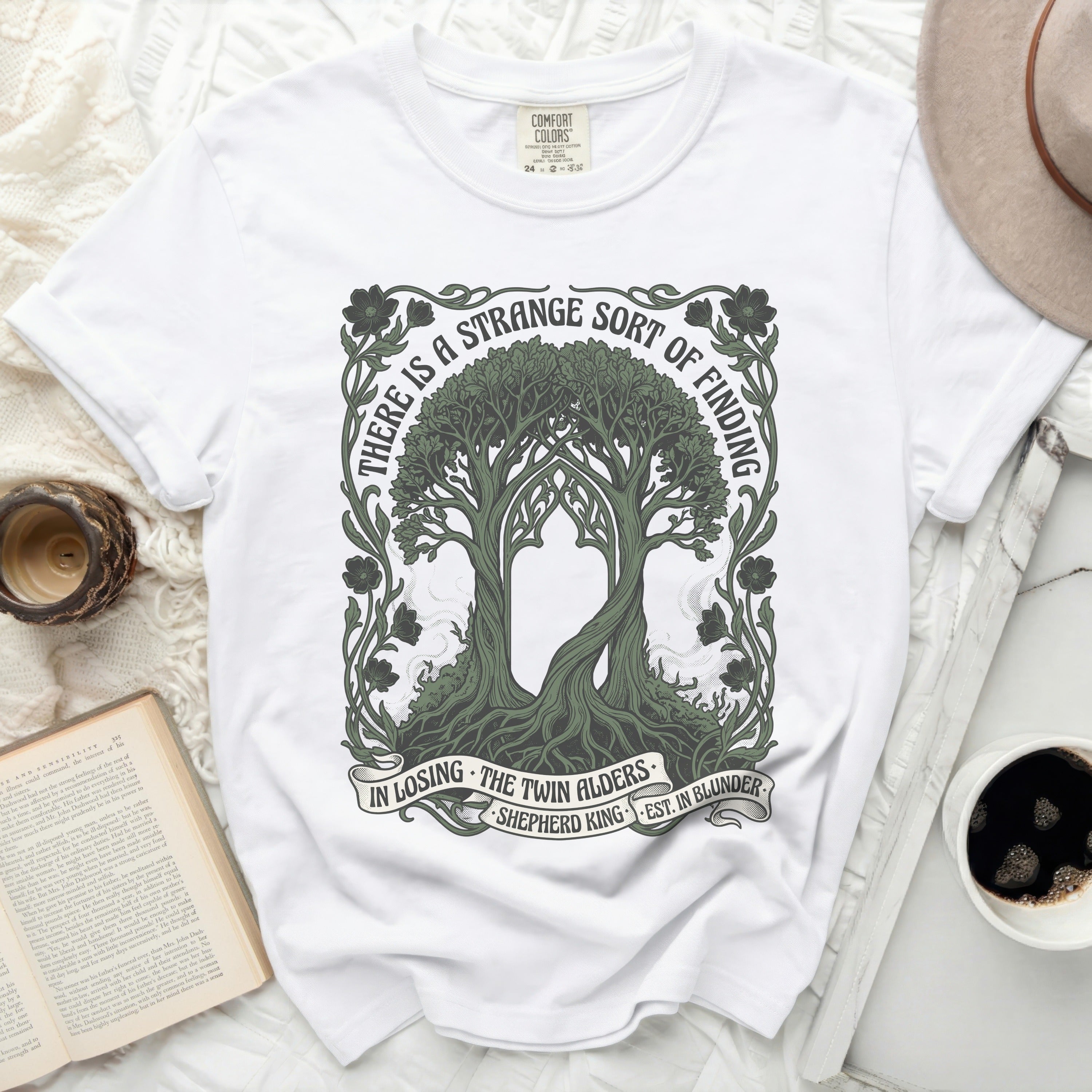 White t-shirt with a graphic design of two trees and text.