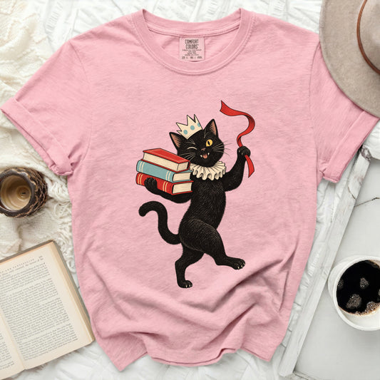 Pink Comfort Colors t-shirt with a graphic of a black cat wearing a crown and holding books.