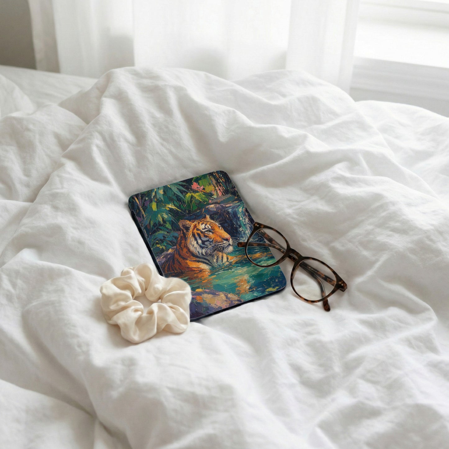 Tiger in lush jungle scene on protective case, with glasses and scrunchie.