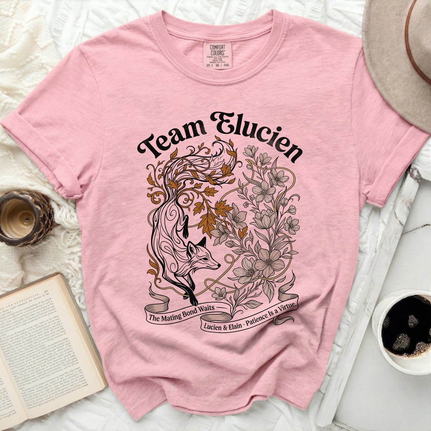 Pink t-shirt with "Team Elucien" text and fox and floral design.