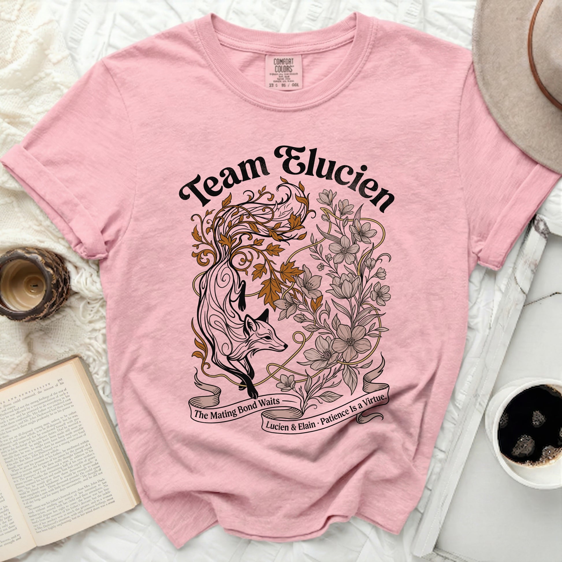 Pink t-shirt with "Team Elucien" text and fox and floral design.