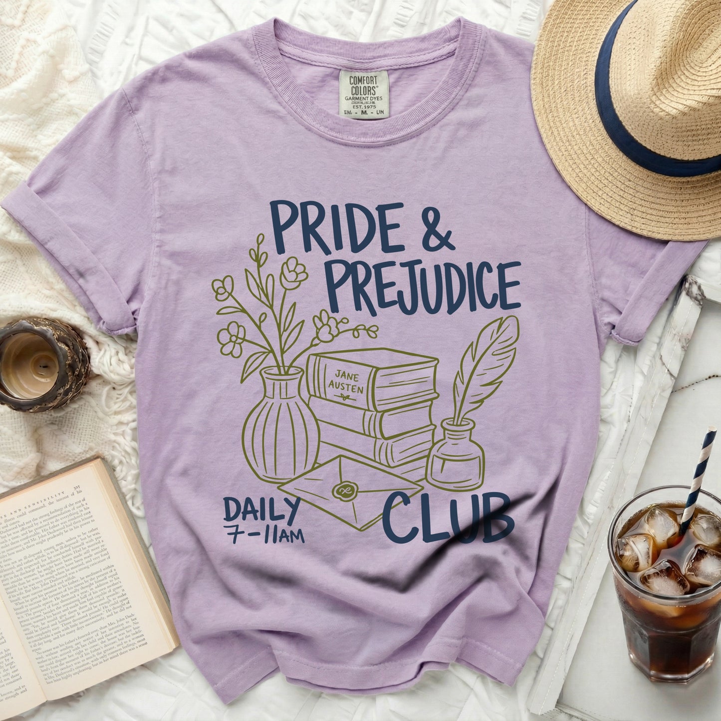 Purple t-shirt with Pride & Prejudice Daily Club graphic and literary elements.