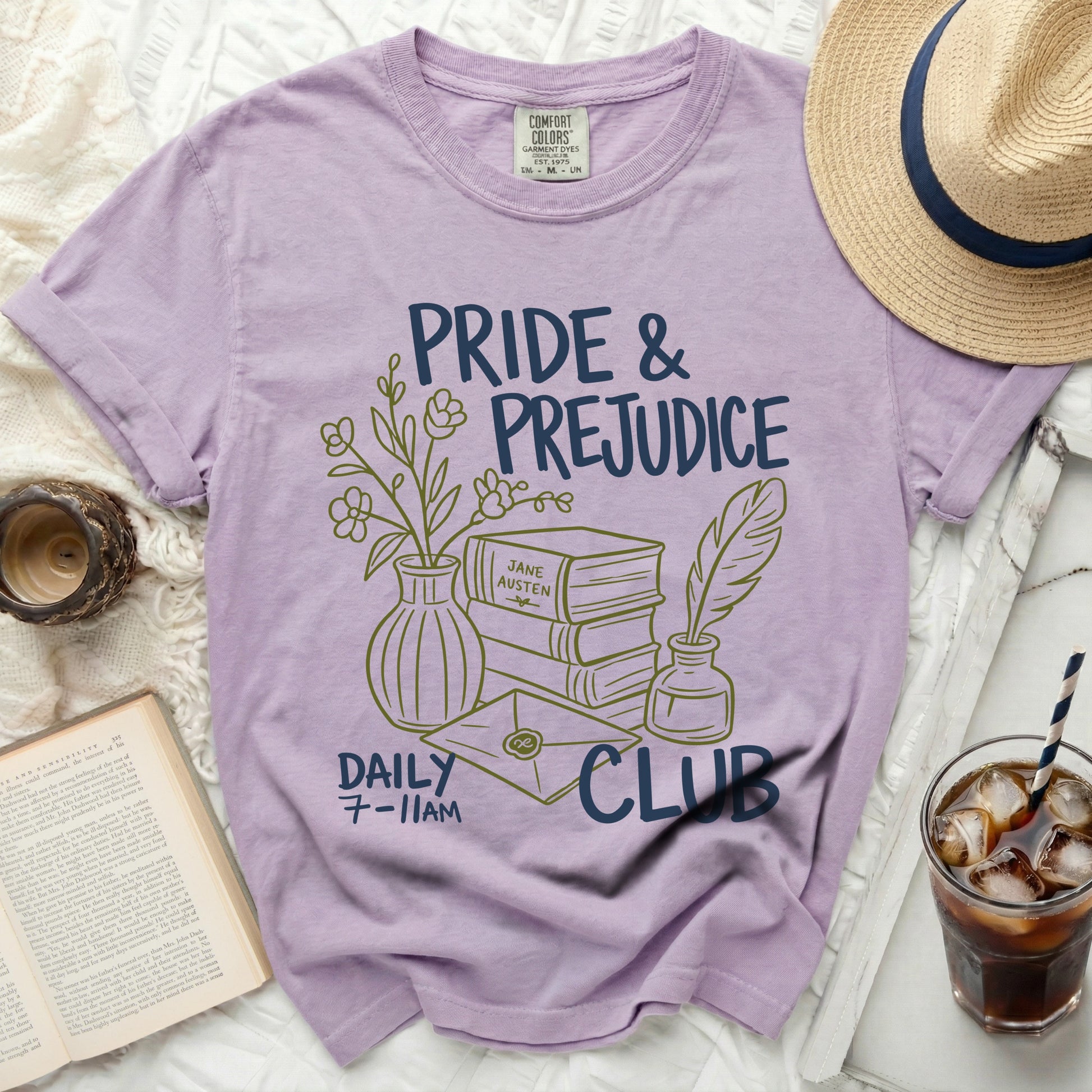 Purple t-shirt with Pride & Prejudice Daily Club graphic and literary elements.
