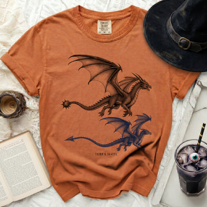 Orange t-shirt with two dragons and text "TAIRN & SGAEYL" below.