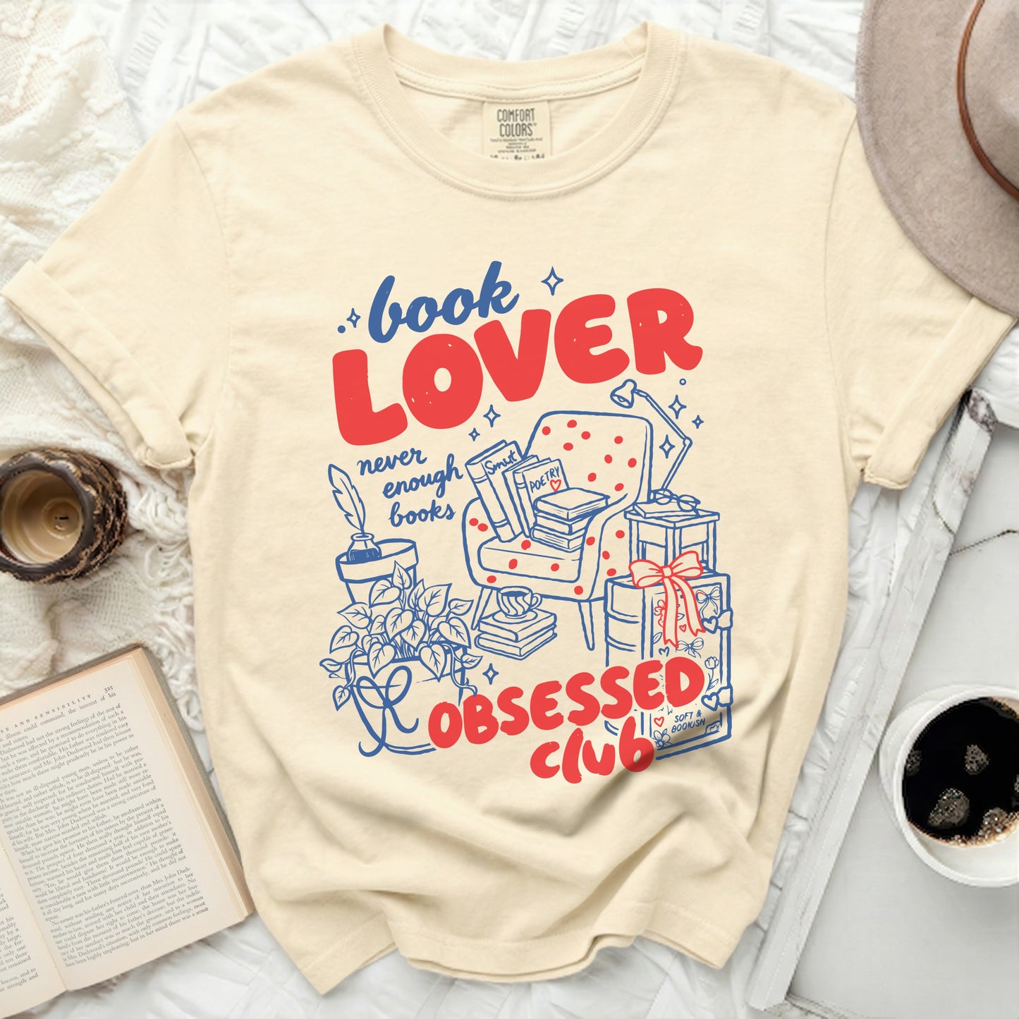 Beige Comfort Colors t-shirt with "Book Lover never enough books Obsessed Club" graphic.