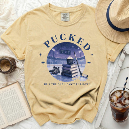 Yellow t-shirt with "Pucked" and hockey graphic, "He's the one I can't put down."