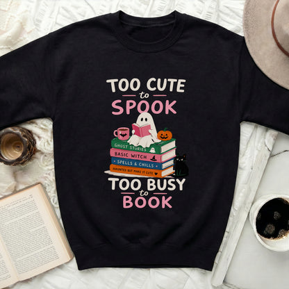 Black sweatshirt with "Too Cute to Spook" and "Too Busy to Book" Halloween-themed design.