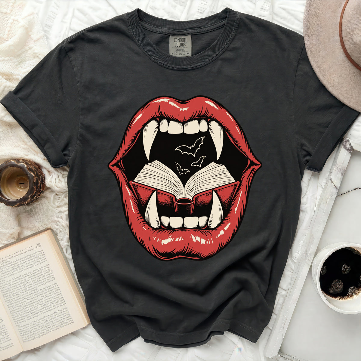 T-shirt graphic of red lips with fangs, open book, and bats.