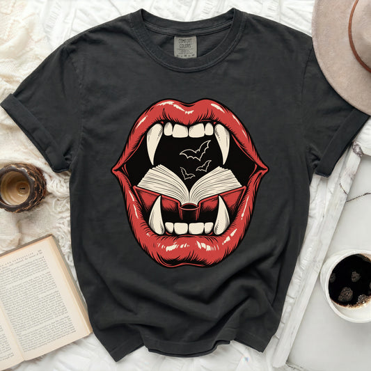 T-shirt graphic of red lips with fangs, open book, and bats.