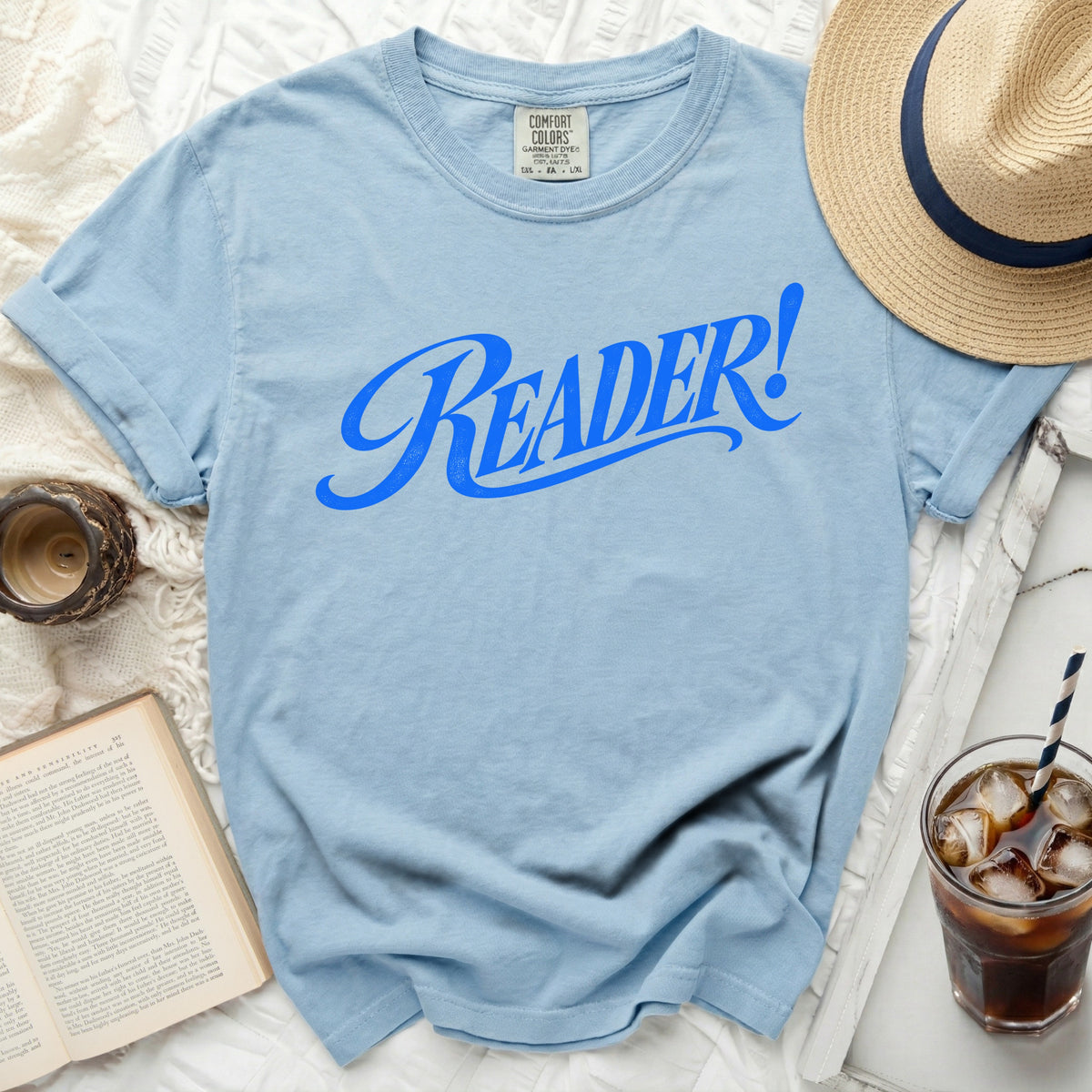 Light blue t-shirt with "Reader!" in blue script text.