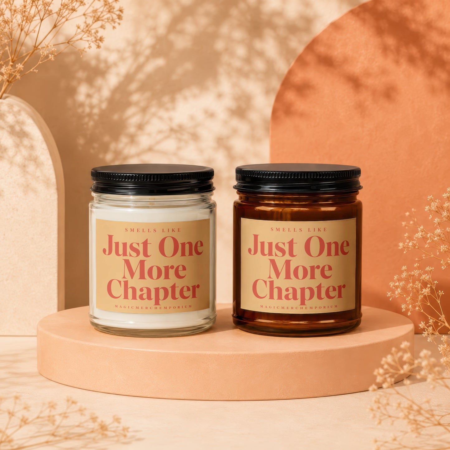 Two candles with "Just One More Chapter" labels on a display stand.