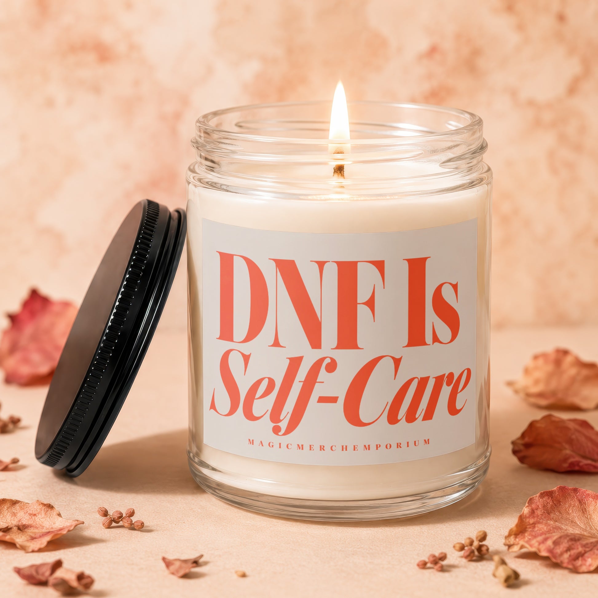 Glass candle with lit wick and "DNF Is Self-Care" label.