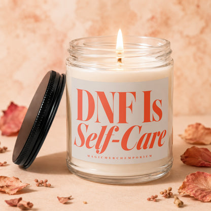 Glass candle with lit wick and "DNF Is Self-Care" label.