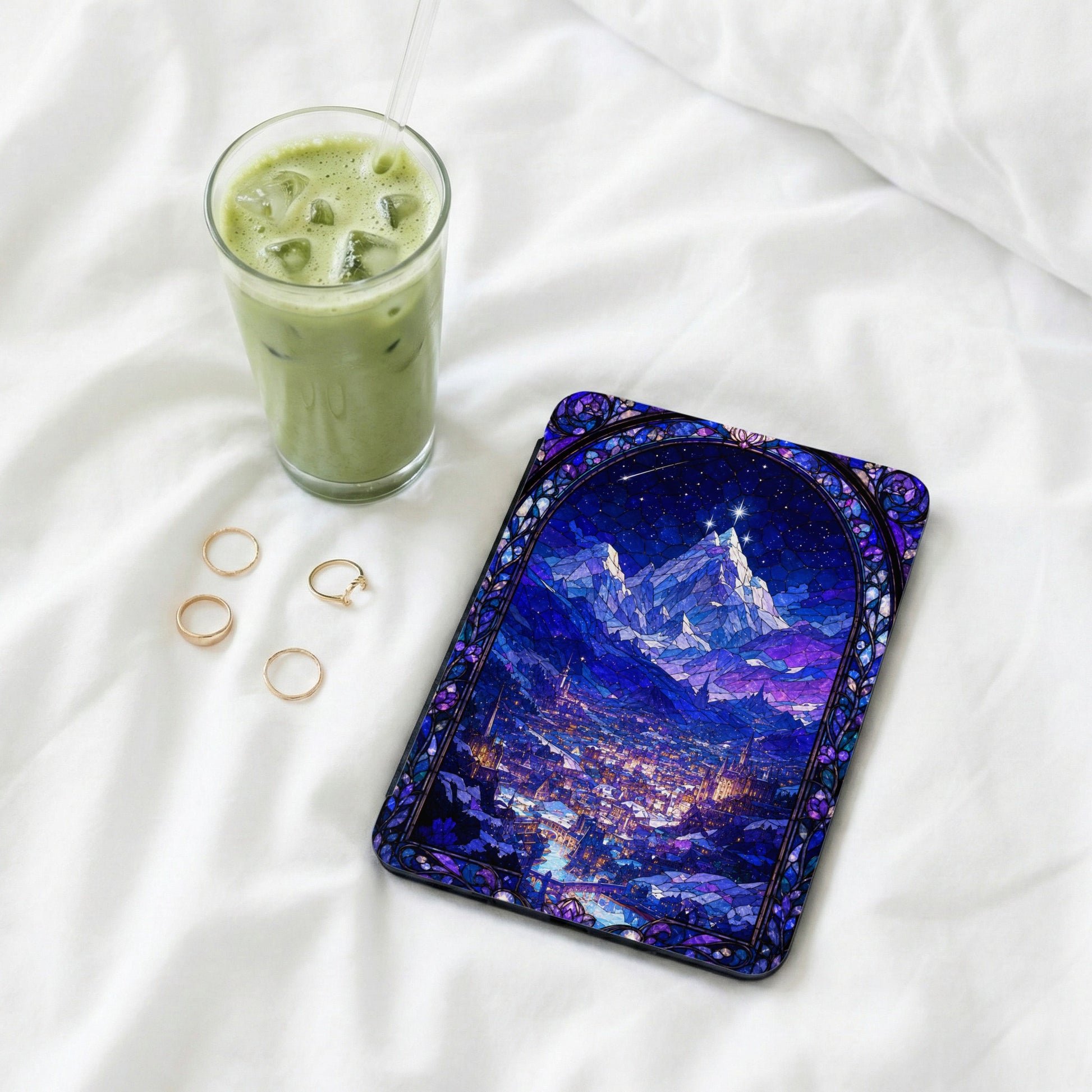 Phone case with stained glass mountain town and starry night design.