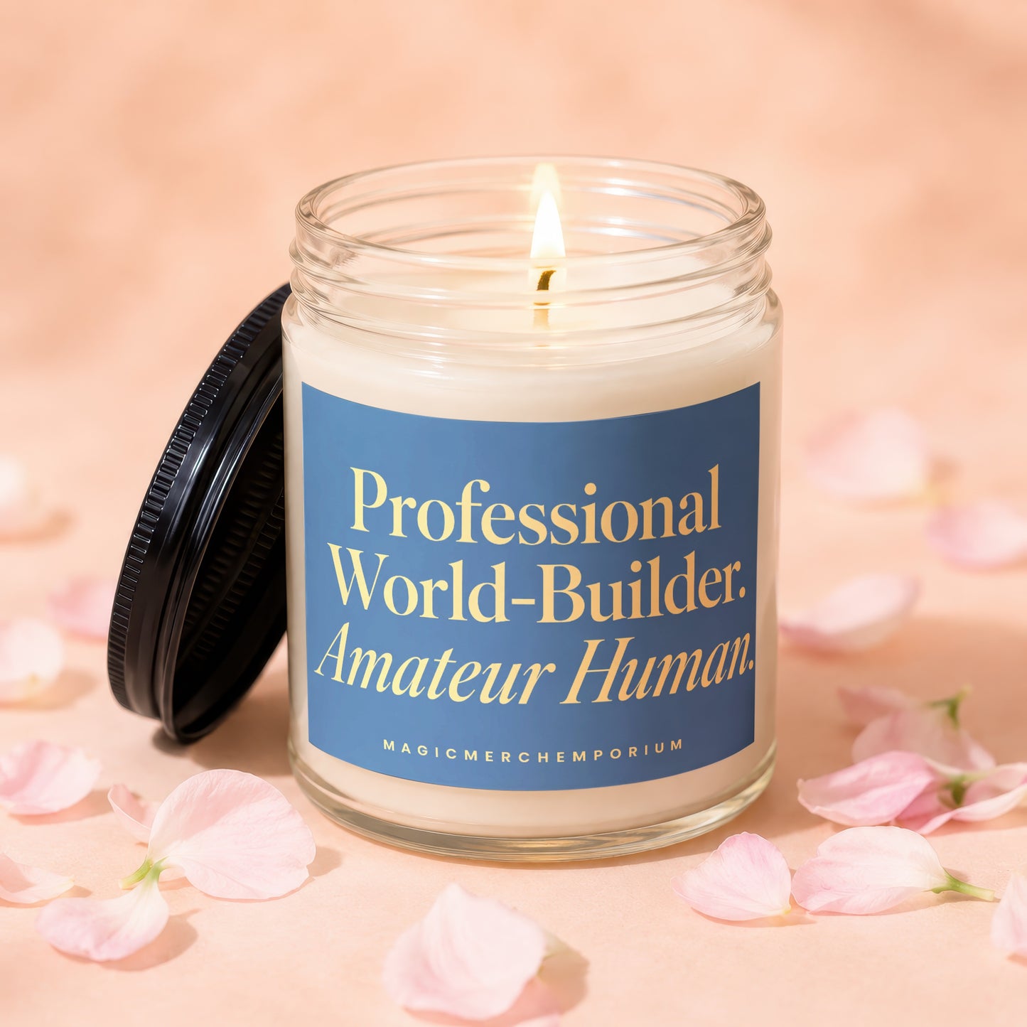 Glass jar candle with lit wick on peachy background, surrounded by pink petals. Text reads: "Professional World-Builder. Amateur Human."