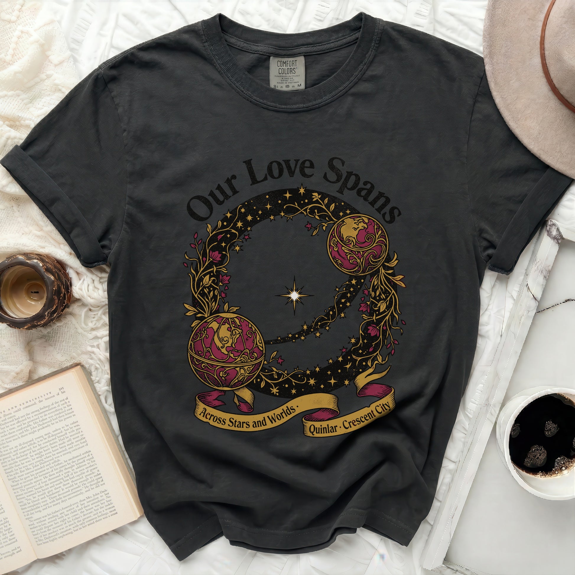 Dark t-shirt with "Our Love Spans Across Stars and Worlds" text and celestial design.