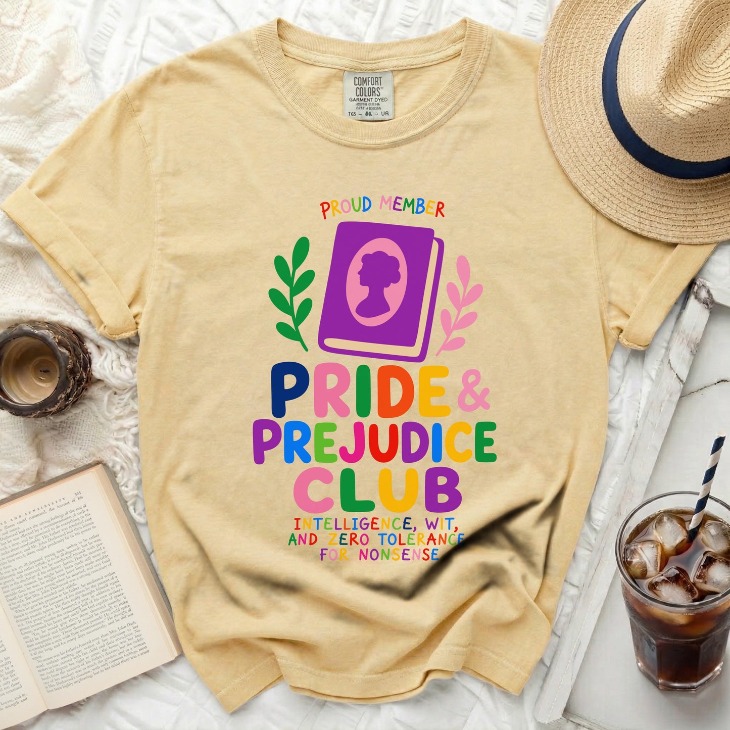 Pale yellow t-shirt with "Pride & Prejudice Club" graphic and reading quotes.
