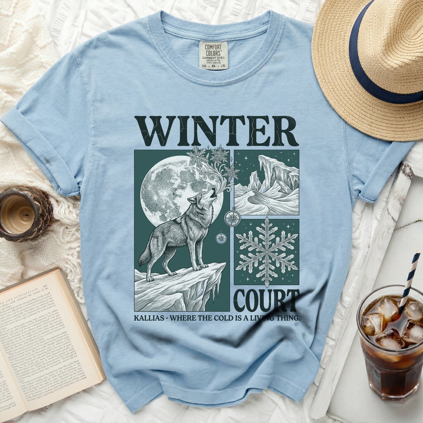 Blue t-shirt with a graphic of a wolf howling at the moon and the text WINTER COURT KALLIAS.