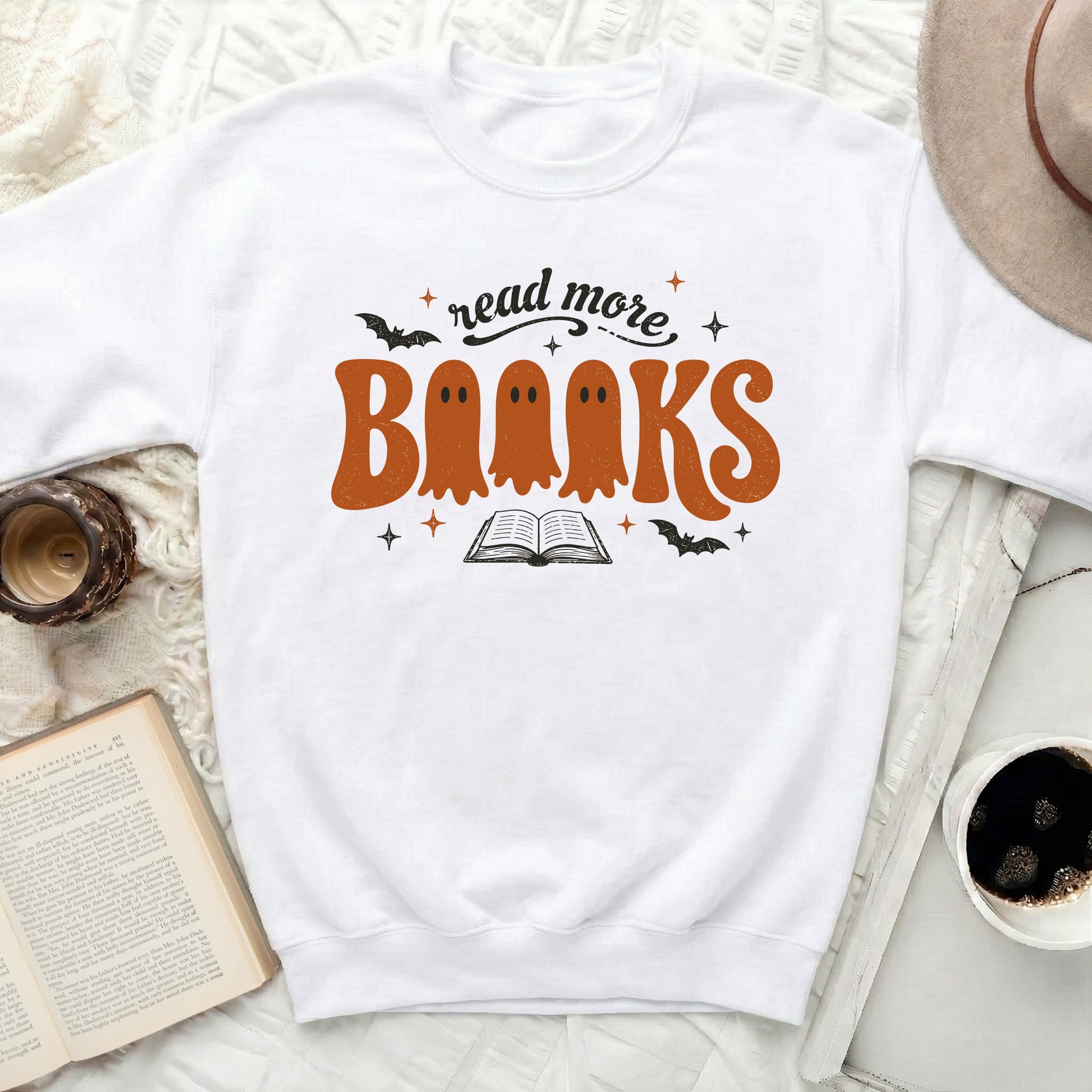 White sweatshirt with "read more Books" text and ghost graphics.