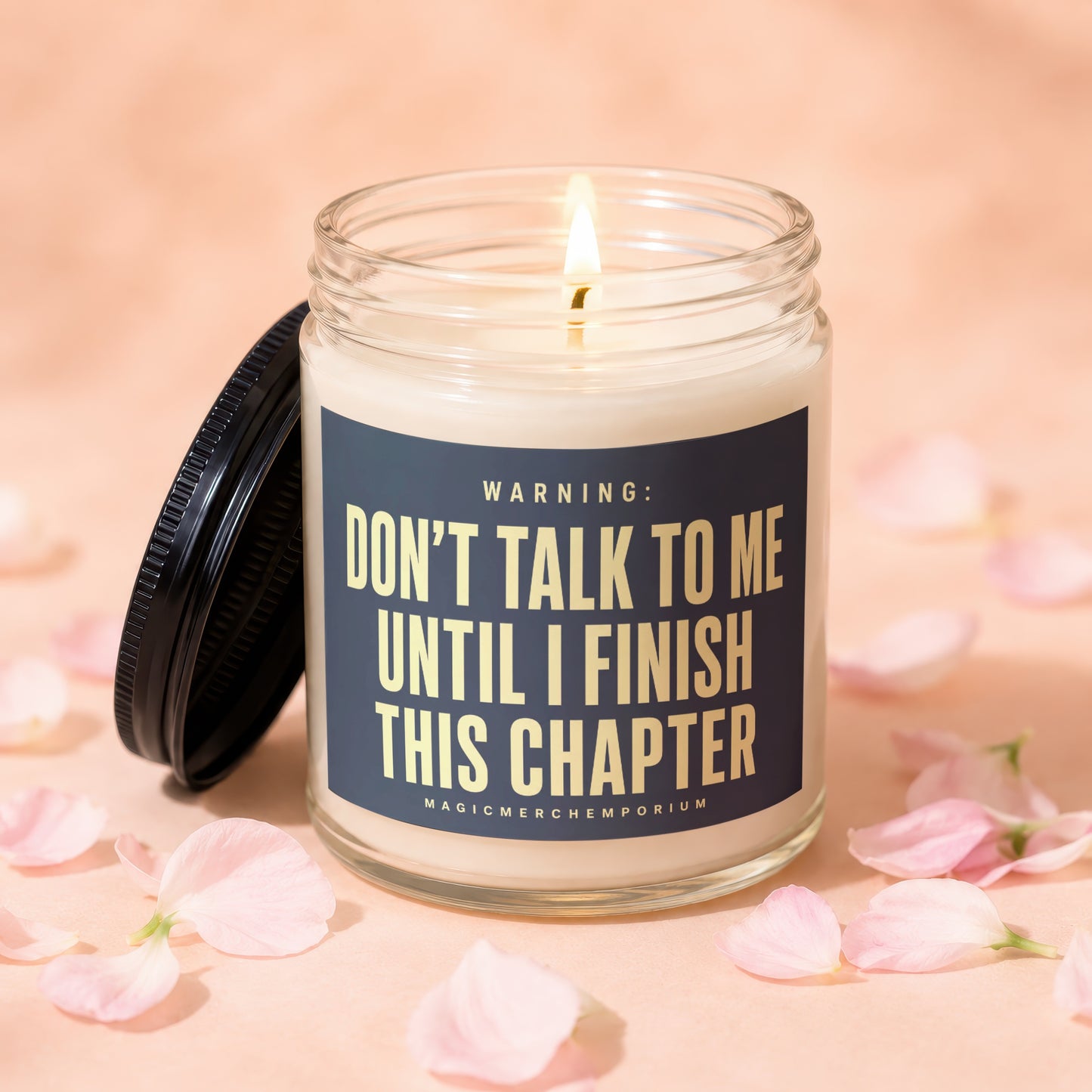 Glass candle with lid off, reading "Don't Talk to Me Until I Finish This Chapter."