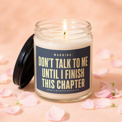 Glass candle with lid off, reading "Don't Talk to Me Until I Finish This Chapter."
