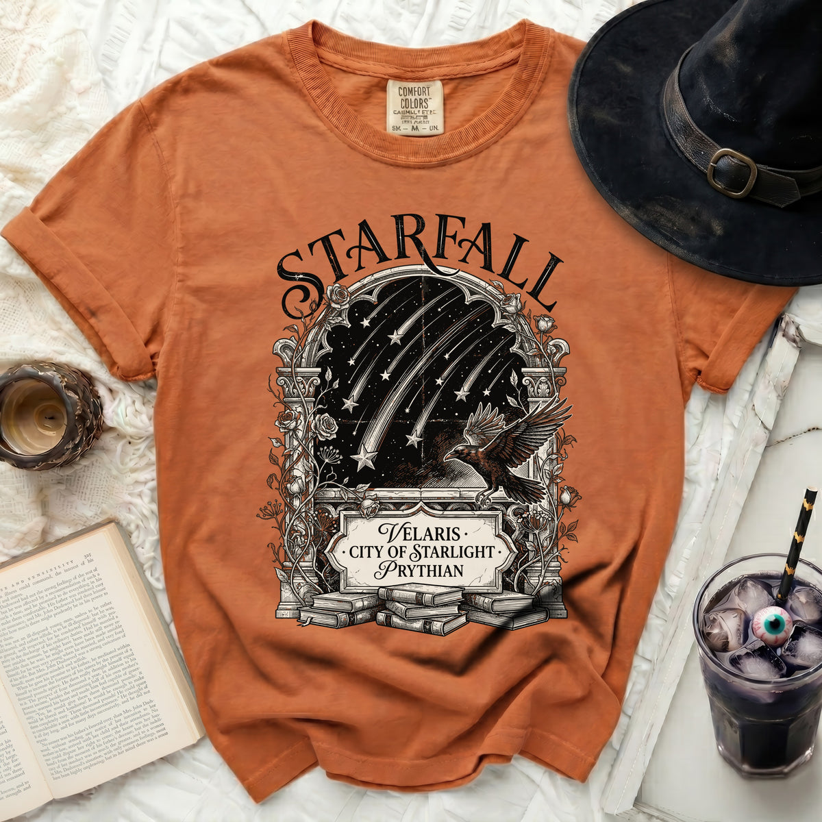 Orange t-shirt with "Starfall Velaris City of Starlight Prythian" graphic and raven.