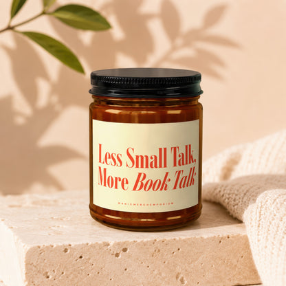 Amber candle with black lid reads "Less Small Talk, More Book Talk".