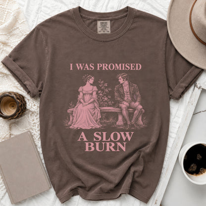 Brown Comfort Colors shirt with pink text "I WAS PROMISED A SLOW BURN" and vintage couple graphic.