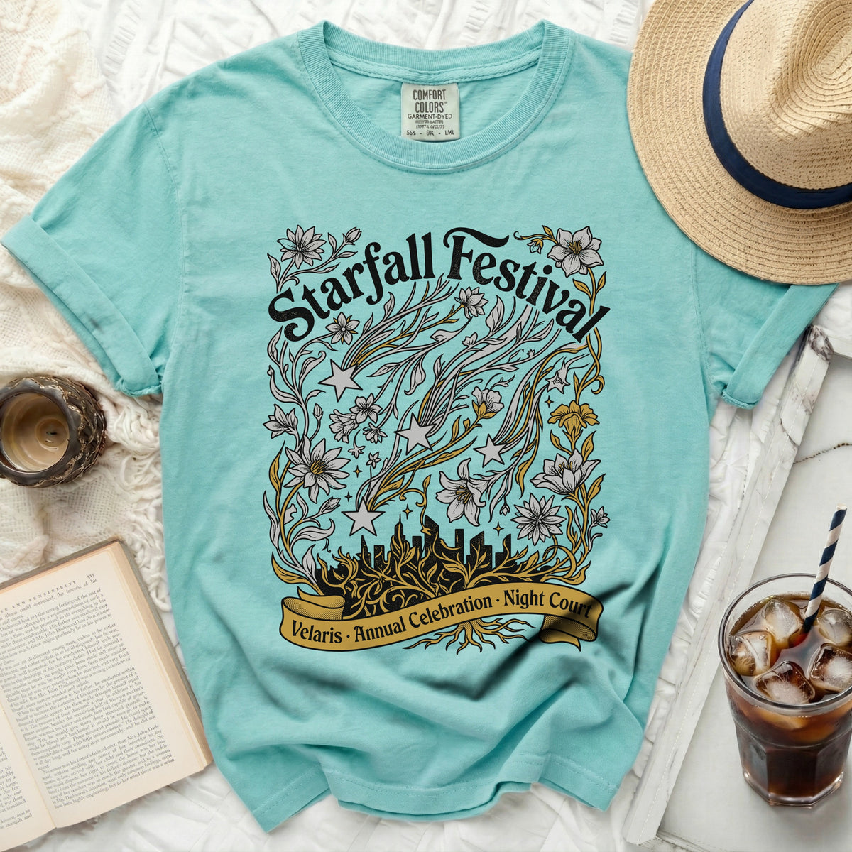 Teal t-shirt with "Starfall Festival" and floral design.