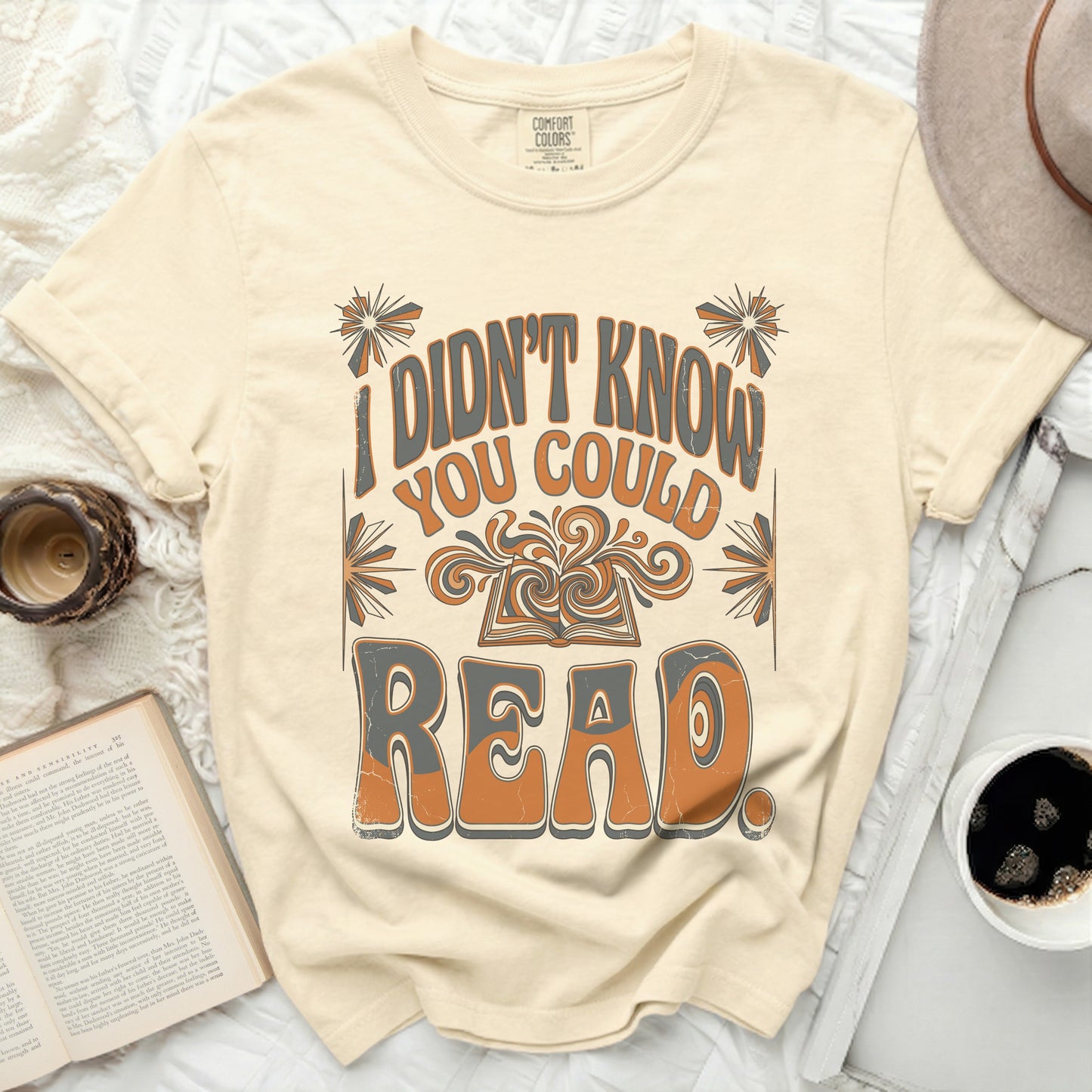 Cream t-shirt with "I didn't know you could read" text and open book graphic.