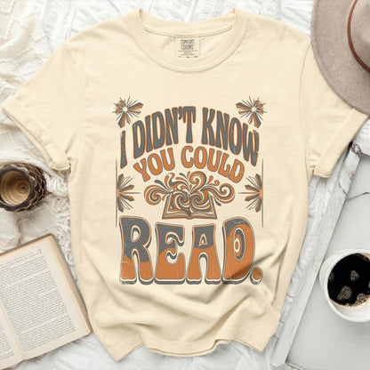 Cream t-shirt with "I didn't know you could read" text and open book graphic.