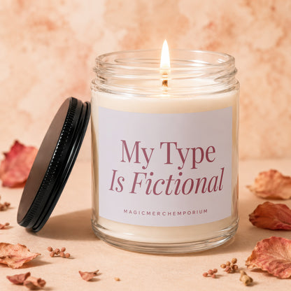 Candle with "My Type Is Fictional" text, lid off, on a pale orange background.