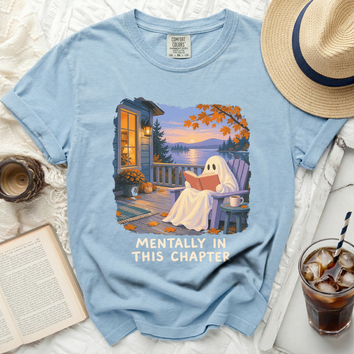Light blue t-shirt with a ghost reading on a porch and "Mentally In This Chapter" text.