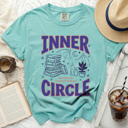 Teal t-shirt with "Inner Circle" text and dark fantasy graphic.