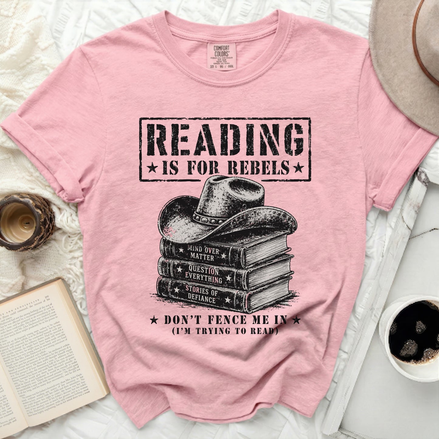 Pink t-shirt with a cowboy hat on a stack of books and rebel text.