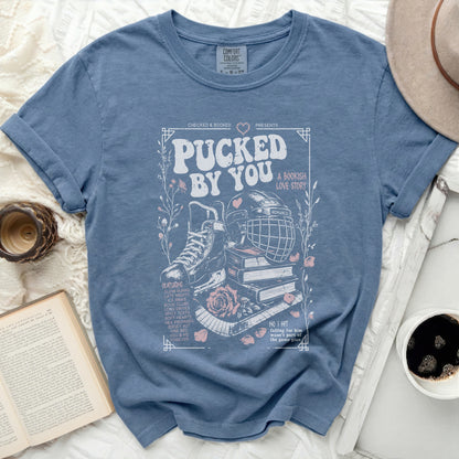 Blue t-shirt with "Pucked By You A Bookish Love Story" and hockey graphics.